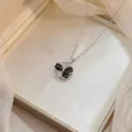 Elegant silver rotating flower necklace featuring black enamel and shiny zircon crystals - Bauhinia Rotating Necklace (X0774) / Silver