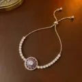 Verstellbares goldenes Tennisarmband mit rotierendem lila Zirkonia Blumendesign für Damen - Armband (TS0124) / Lila