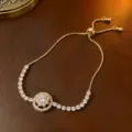 Elegantes goldfarbenes Armband mit drehbarer Zirkonia-Blume, verstellbarer Schiebeknoten. - Armband (TS0212) / Gold