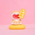 Detailed macro view showing a cute shouting cat resin figurine on its yellow magnetic base - Fighting Shiba Inu / Beige