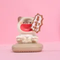 Close-up of a shouting cat figurine with 'Get Rich' speech bubble detail for desk. - Wealthy Cat / Off White