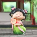 Close-up of a cute Tang dynasty style girl resin figurine holding a lotus fan decor - Lianqu Style
