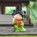 Close-up of a cute Tang Dynasty style girl resin figurine holding a fruit basket - Qiuyue Style