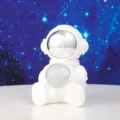 Close-up view of a cute white astronaut figurine holding a crystal ball night light - 1 Piece / Small Sitting Star Light B