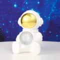 Detail view of a white astronaut night light holding a crystal planet ball for bedside decor. - 1 Piece / Small Sitting Star Light A