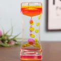 Primer plano de temporizador de movimiento líquido bicolor con gotas de clepsidra - Rosa Amarillo