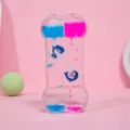 Detalle del reloj de arena líquido azul y rosa con motivos de delfines - Forma de Hueso (Delfín Único) / Azul y Rosa