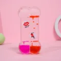 Primer plano del temporizador de gotas de aceite en forma de hueso con fluidos rosa y rojo - Forma de Hueso (Estampado Labios) / Rojo-Rosa Bicolor