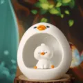 Close-up of a cute cartoon duck resin night light with a star light wire inside. - Blink Eyes / White