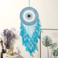 Blue evil eye feather dream catcher detail, bohemian style wall hanging for bedroom decor. - L Blue