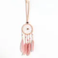 Detail view of ethnic pink dreamcatcher necklace with delicate feathers and beads - Lotus root pink