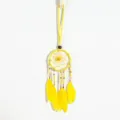 Close-up detail of yellow ethnic dreamcatcher necklace with vibrant feathers and beads - Lemon Yellow