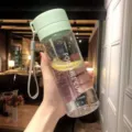 Portable plastic water bottle with green lid and strap, ideal for sports and daily use. - 600ml [Transparent] Light Green