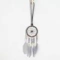 Detailed view of a handmade dreamcatcher necklace with grey feathers and beads - Gray