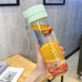 Clear plastic water bottle with portable strap, ideal for outdoor sports, fitness and daily use. - 600ml / Transparent Green
