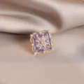 Elegant close-up of a vintage purple enamel brooch featuring pearls and crystals. - 739#紫色方块