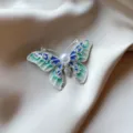 Detailed macro view of an elegant butterfly brooch with pearls and blue enamel wings - 879# Green Butterfly (Brooch 878) / Green Butterfly