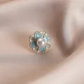 Close-up macro view of an elegant flower brooch with a pearl center on silk fabric background. - 748#蓝色