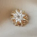 Elegant sunburst flower brooch with clear marquise crystal stones on champagne silk - White