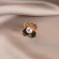 Close-up detail of an elegant vintage floral brooch with a white pearl center - 751#双色四叶草