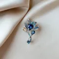 Close-up of an elegant floral crystal brooch with deep blue rhinestones on silk fabric - Blue Tulip Brooch (883) / Blue
