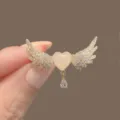 Exquisite heart-shaped brooch with shimmering wings and a teardrop crystal dangle. - Angel Wings (222#)