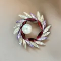Elegant wreath brooch featuring multicolored crystals and a large central pearl for suit lapels - Purple Wreath