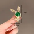 Close-up detail of golden rabbit brooch with green stone showing 4cm x 2.5cm dimensions - 绿色兔子(239)