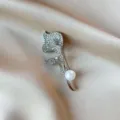 Elegant silver-toned floral brooch pin with sparkling rhinestones and a white pearl accent. - Silver Tulip Style (840) / Silver Rhinestone Tulip