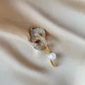 Elegant gold flower brooch pin featuring sparkling crystals and a lustrous white pearl - Gold Tulip Style (839) / Gold Rhinestone Tulip