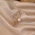 Elegant gold leaf brooch with sparkling rhinestones and pearl, perfect for coat or dress accessory. - Tulip / Gold