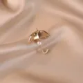 Elegant golden umbrella brooch pin with a dangling white pearl on champagne satin - Umbrella / Gold