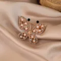 Elegant gold-tone butterfly brooch with sparkling rhinestones and faux pearls chic. - Gold Butterfly / Gold