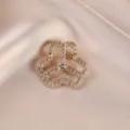 Elegant gold-toned rhinestone brooch for women, sparkling crystal floral coat accessory pin. - Three-Petal Flower / Gold