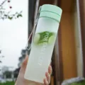 Frosted plastic water bottle with lid and portable strap for outdoor sports and daily use. - Matte Green