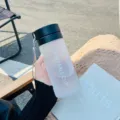 Frosted plastic water bottle with black lid and strap, portable simple sports cup for daily use. - Matte Suede Style / 600mL / Cool Black