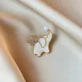 Elegant white elephant brooch with crystal wings and pearl accent on champagne silk fabric. - Pearl Elephant Style (857) / Gold/White