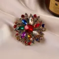 Vintage floral crystal brooch detail showing multi-color rhinestones and antique gold alloy finish. - Multicolor Floral / Colorful