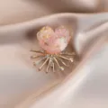 Exquisite colorful floral brooch detail, shimmering crystal heart design with radiant gold metal base. - Orange Pink
