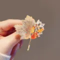 Close-up of exquisite maple leaf brooch with orange and yellow crystals - Maple Leaf Yellow