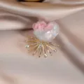 Colorful floral brooch with rhinestone crystal and gold-tone metal starburst base. - Pink White