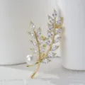 Elegant gold-tone leaf brooch with sparkling marquise crystals and a round white pearl. - Tree Branch
