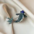 Elegant koi fish brooch encrusted with blue and teal rhinestones shown on silk fabric - Vibrant Koi Fish Style (904)