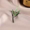 Close-up detail of a green bamboo leaf brooch with elegant metallic finish on silk - Green Bamboo Leaf Style (673#)
