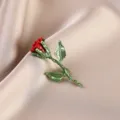 Macro detail of an elegant red rose enamel brooch pin with green leaves on silk fabric. - Red Rose with Green Leaf (674#)