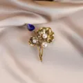 Detailed close-up of vintage gold lotus leaf brooch with blue crystal and pearls - Sapphire Lotus Brooch (760#)