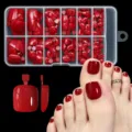 Detailed view of dark red press-on toenails showing packaging and application effects - 120Pcs Solid Glossy Wine Red