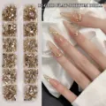Premium 12-Raster-Set goldene flache Nagelkunst-Strasssteine mit verschiedenen Mischformen - Champagner (12 Gitter)