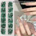 Detailansicht der grünen 12-Gitter-Nagelstrasssteine auf langen Fingernägeln angewendet - Dunkelgrün (12 Gitter)