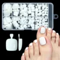 Detailed view of 120 white press-on toenails in a storage box with a model wearing them - 120Pcs Solid Glossy White